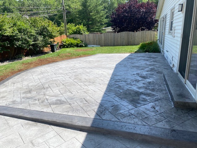 Decorative stamped concrete patio installation in Newark, Delaware