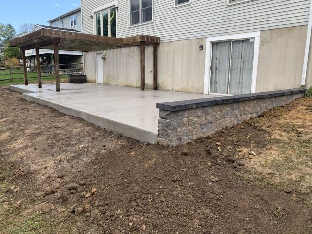 Stamped concrete patio with retaining wall installation in Bear, Delaware